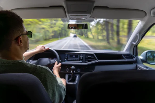 Person driving a car safely with windscreen protection