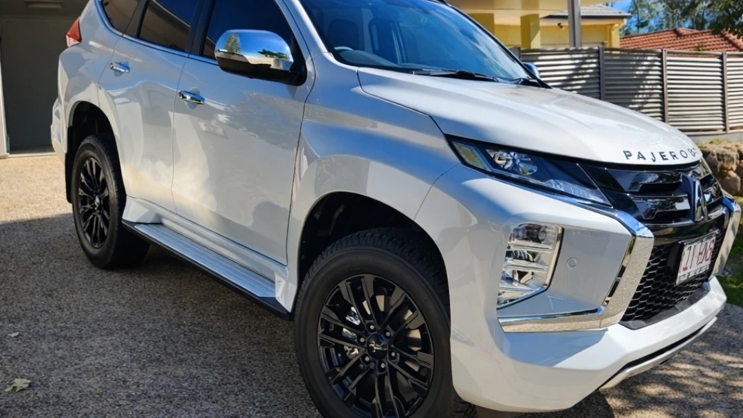 Car window tinting in Brisbane on a white Mitsubishi Pajero Sport with dark legal window film by Glass Tinting Solutions