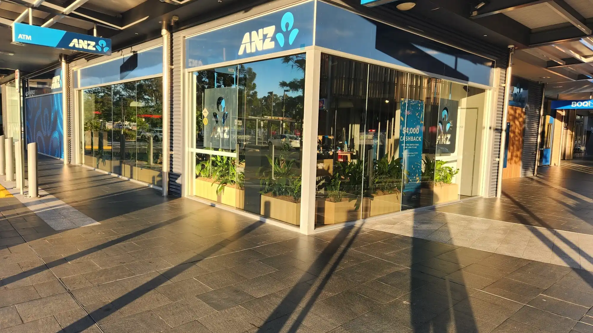 Commercial window tinting in Brisbane on an ANZ corner shopfront with reflective glass film by Glass Tinting Solutions