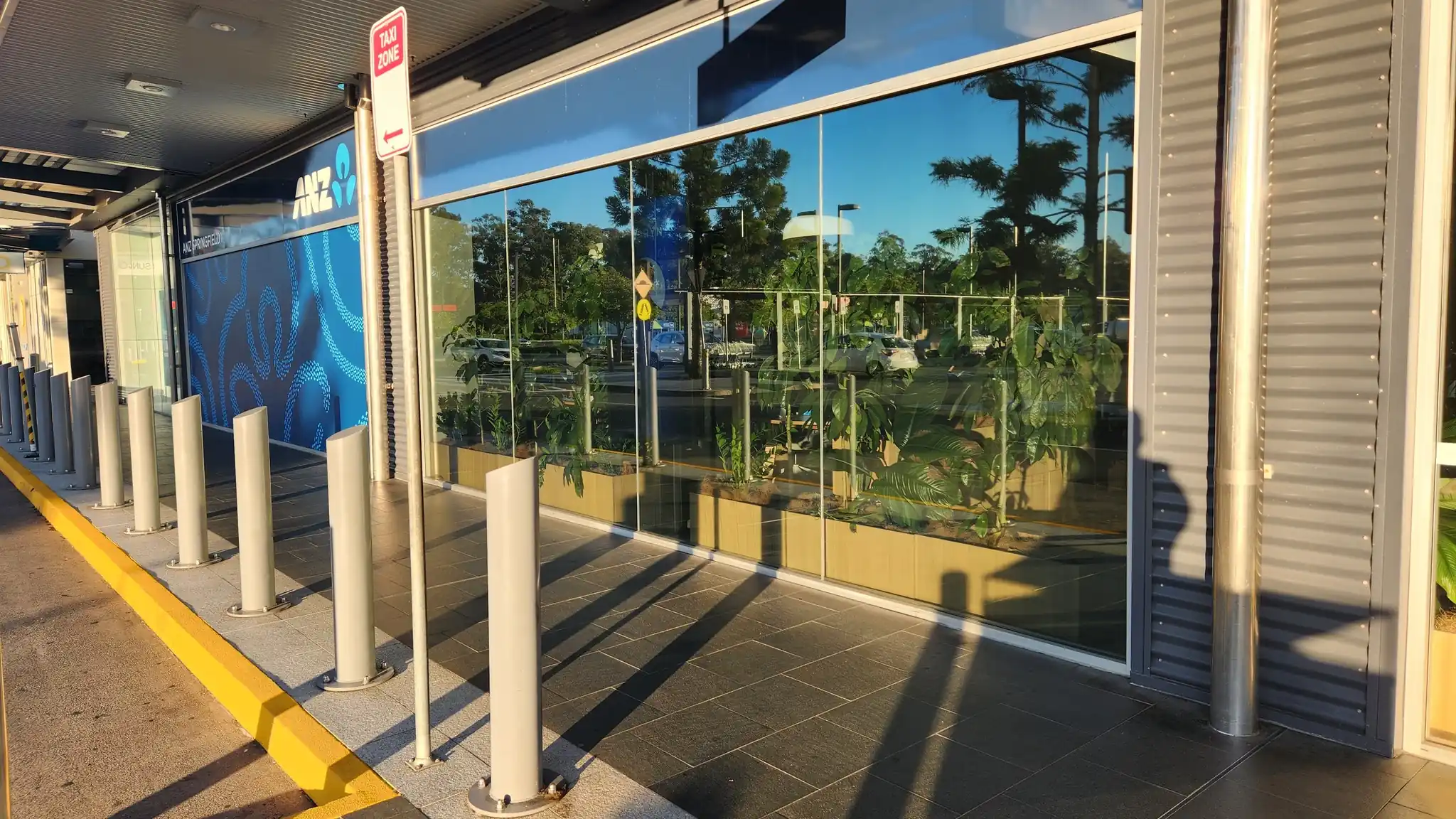 Commercial window tinting in Brisbane on an ANZ storefront with reflective window film installed by Glass Tinting Solutions
