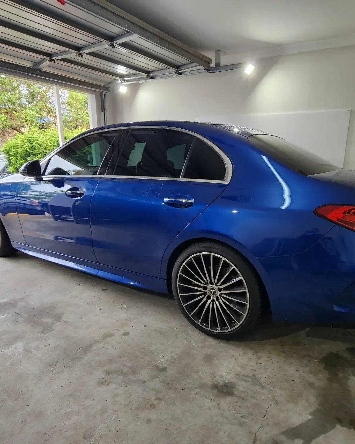 Blue sedan with ceramic paint protection in Brisbane by GTS showing a glossy finish inside a garage