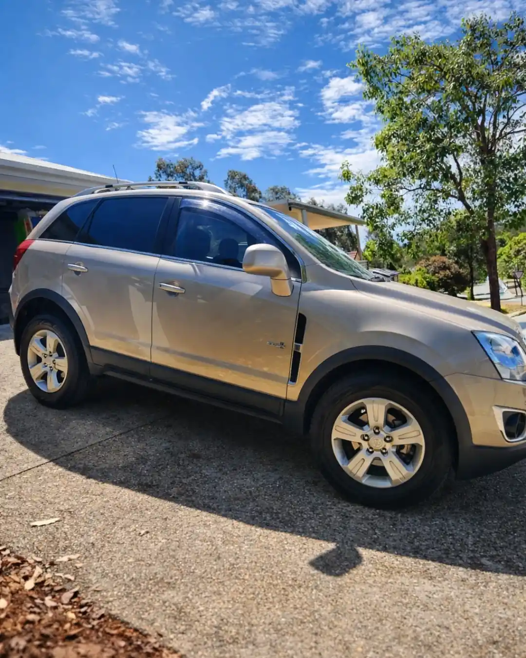 Gold SUV with ceramic paint protection in Brisbane by GTS showing a clean glossy finish in a driveway