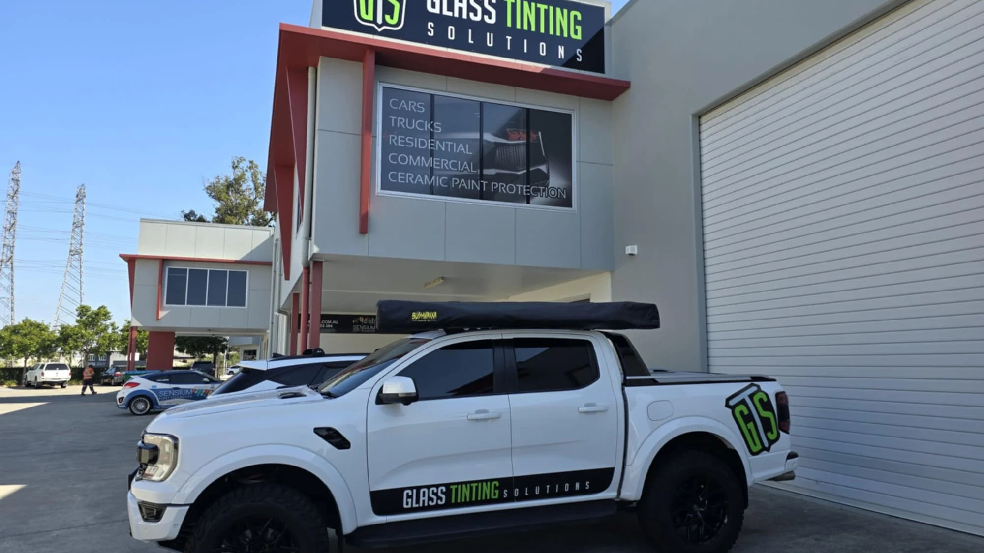 Glass Tinting Solutions shopfront in Seventeen Mile Rocks with a white ute parked out front