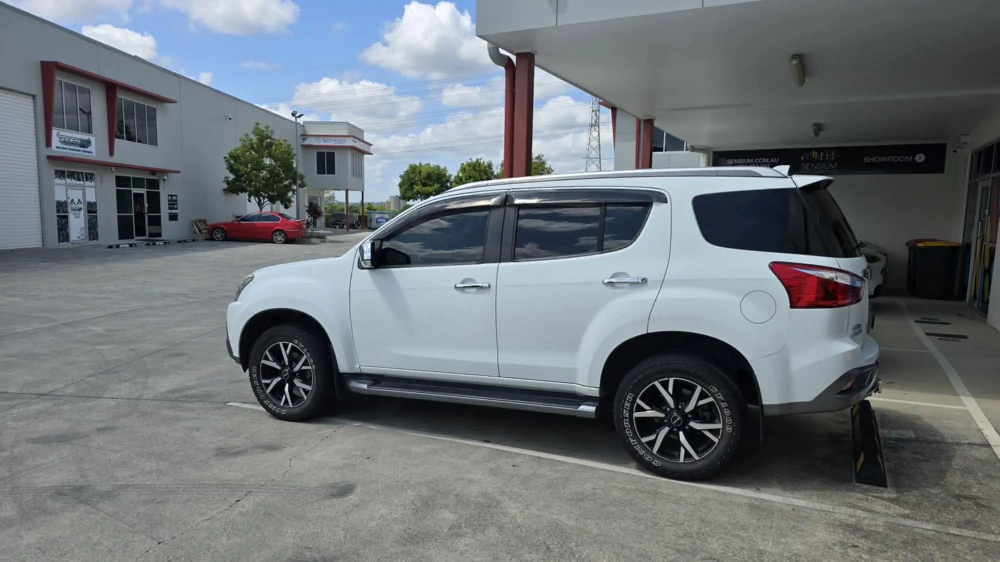 White Isuzu MU-X 4WD with dark car tinting on side and rear windows, done by GTS car tinting