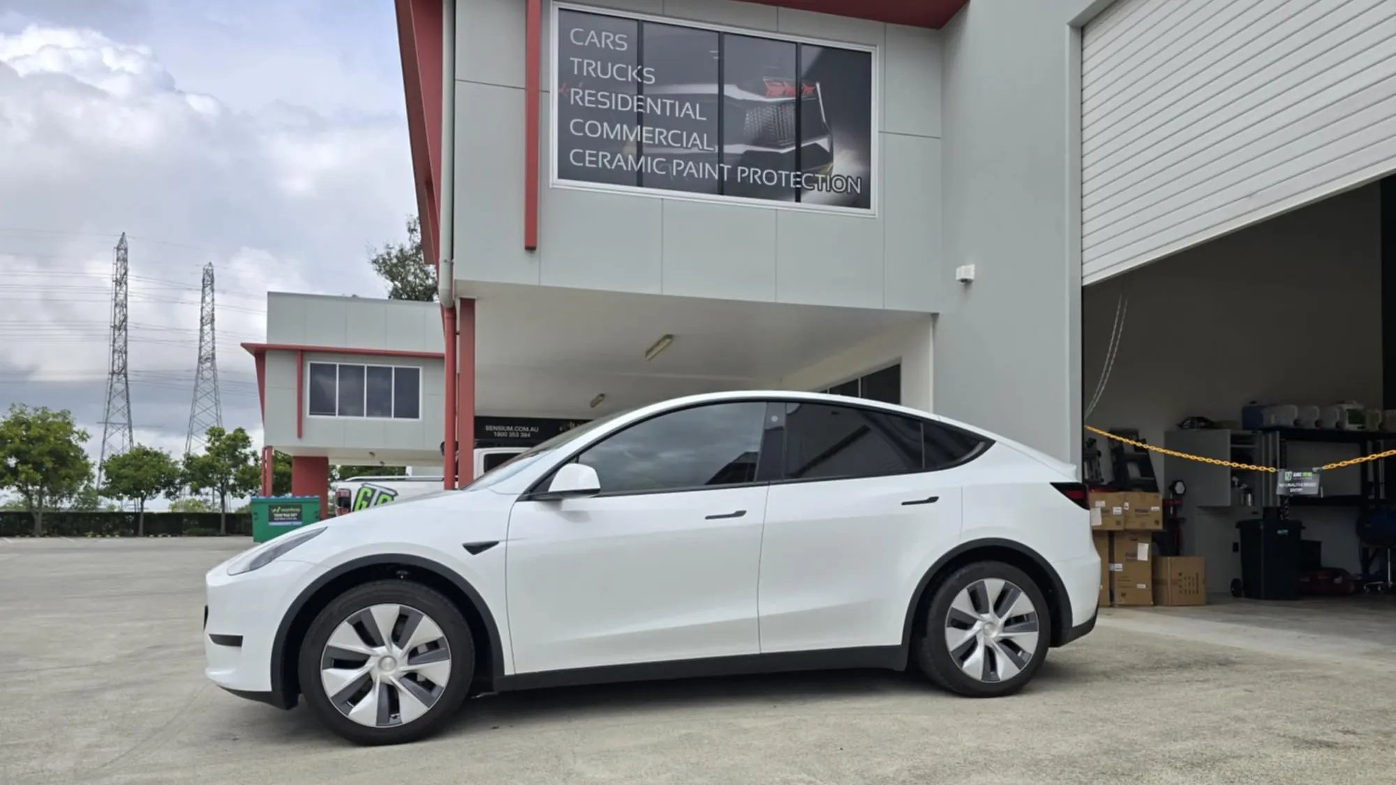 White Tesla Model Y electric car with professional window tint installed by GTS car tinting